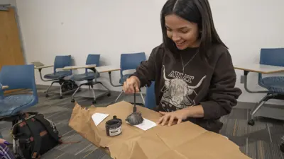 Criminal justice student practices dusting for fingerprints