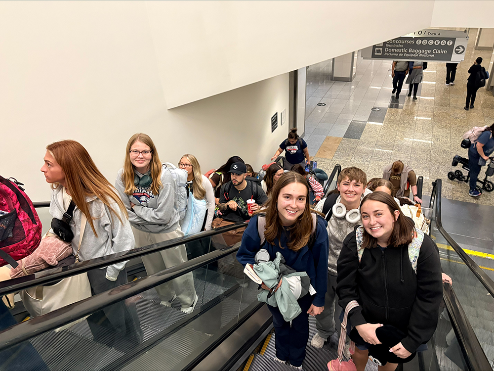 Students on airport escalator