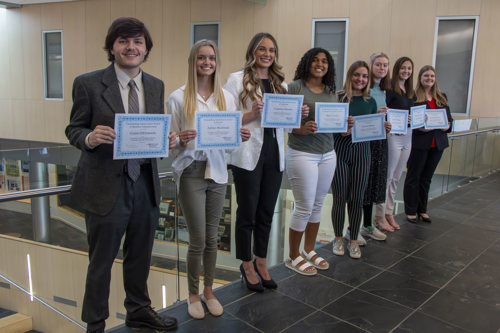 Students holding their certificates