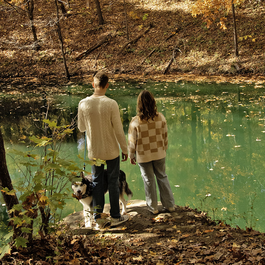 Students and their dog pause at a rock overlook on the Bent Twig Trails. 