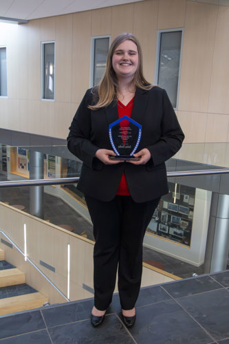 Audrey holding award