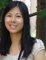 Amie Whittemore standing by a pond in the woods