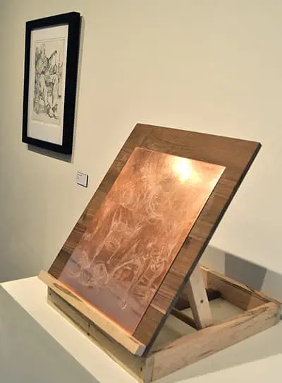 Printmaking plate next to finished print