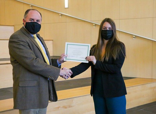 Thomas presenting certificate to Mara