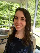 Amie Whittemore standing by a pond in the woods