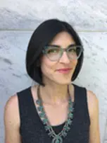 Amie Whittemore standing by a pond in the woods