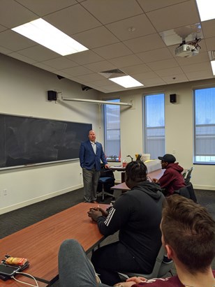 Tim talking to class